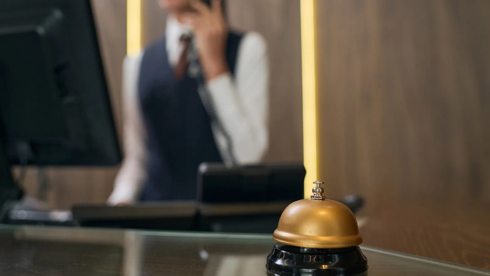 A brass bell on a hotel reception desk